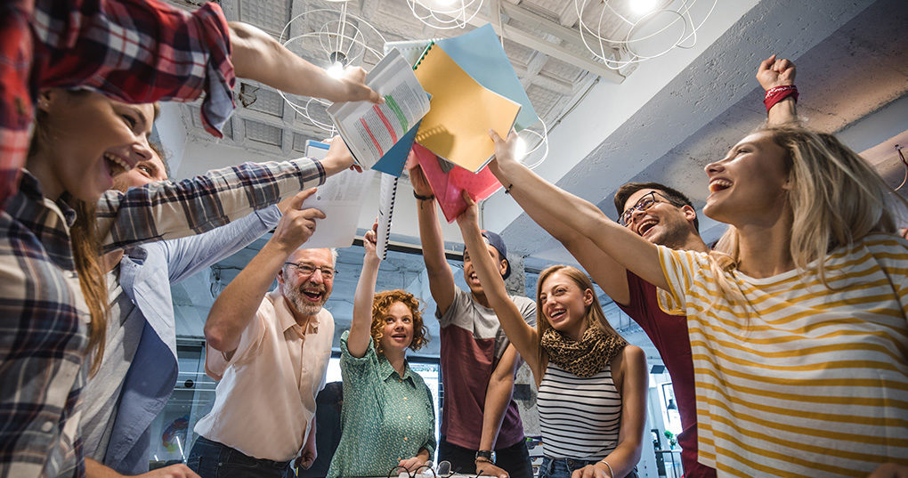 Happy employees in a team environment.